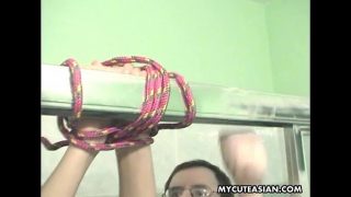 Asian babe roped up and covered in cream